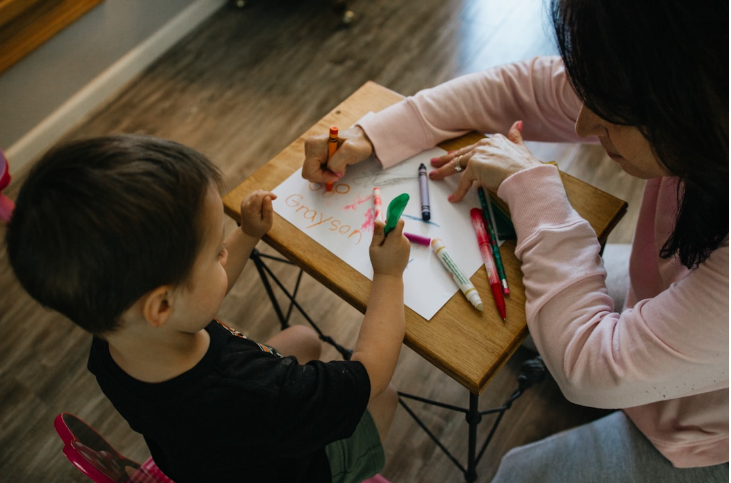 Professional working with young children in an early childhood education setting.