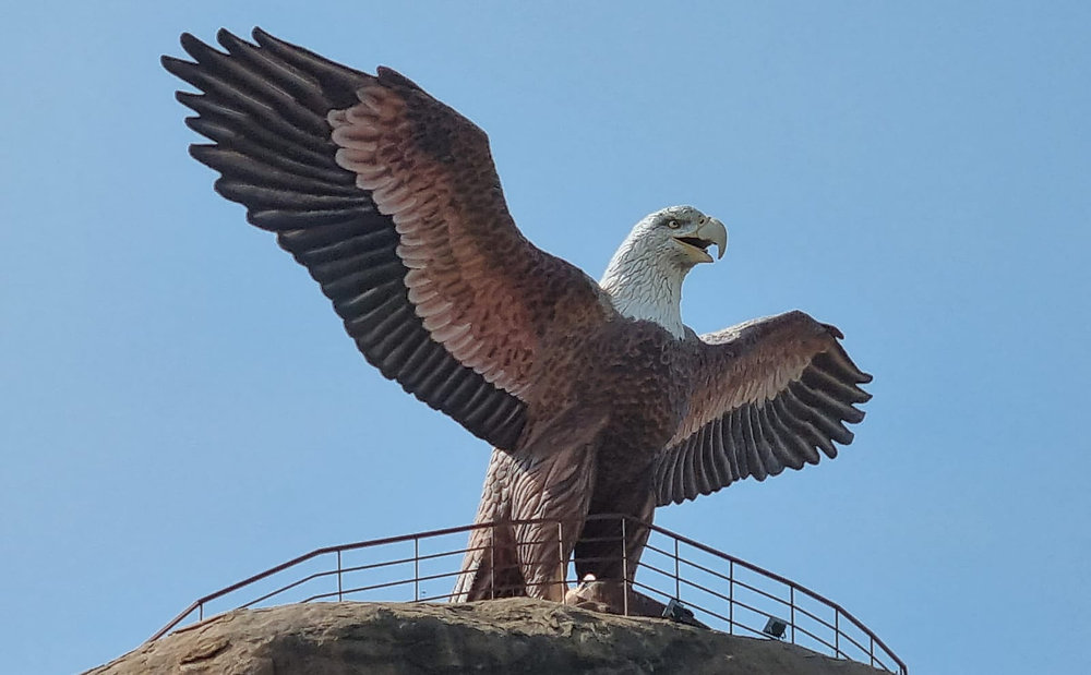 Jatayu statue at Lepakshi Temple with wings spread wide, symbolizing sacrifice and devotion against a clear blue sky.