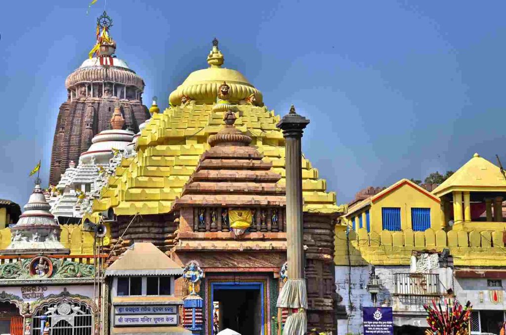 Jagannath Temple Puri showcasing the golden Nilachakra shrine and the towering main spire under a clear blue sky in Odisha