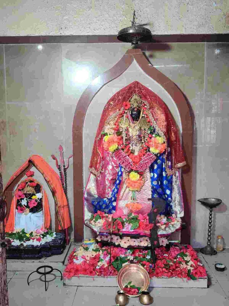 Bahula Devi idol decorated with red and blue saree and floral garlands at Bahula Shaktipeeth Ketugram