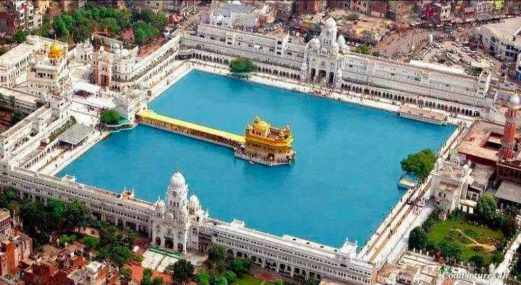 Aerial view of the Golden Temple Harmandir Sahib surrounded by the sacred Amrit Sarovar in Amritsar Punjab