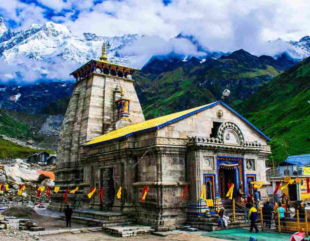 Kedarnath Temple surrounded by snow-covered Himalayan mountains