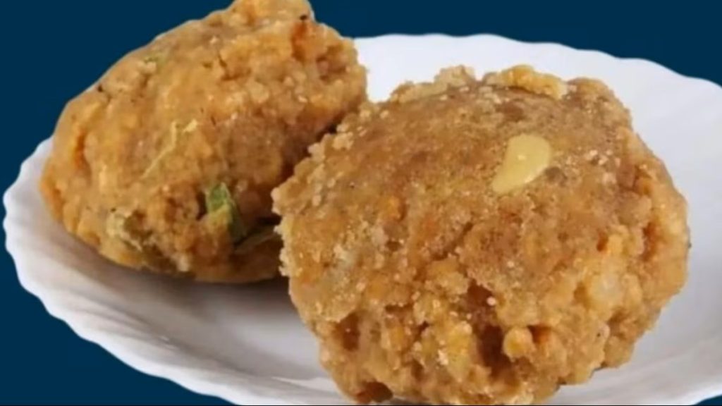 Tirupati Laddu prasadam served on a white plate, a famous sweet offered at Tirumala temple.