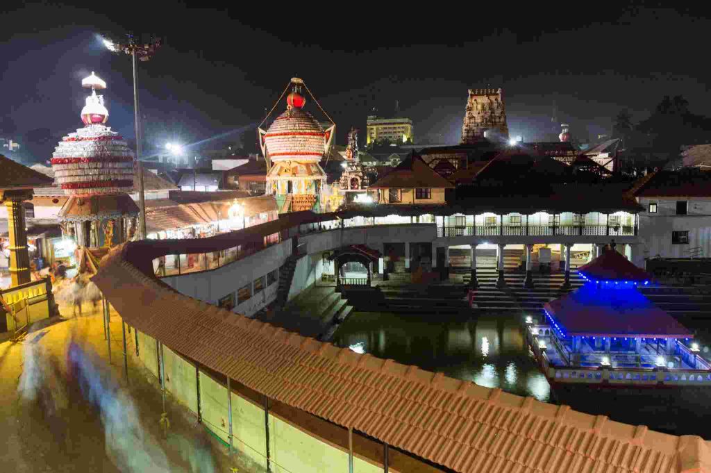 Udupi Sri Krishna Temple illuminated at night with chariots and temple structures