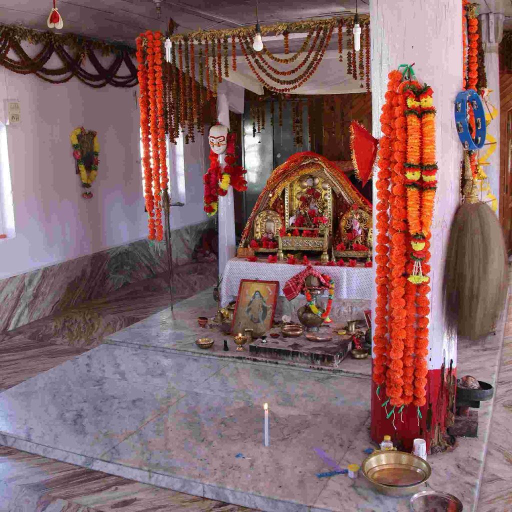 Decorated interior of Nartiang Durga Temple with marigold garlands and sacred altar